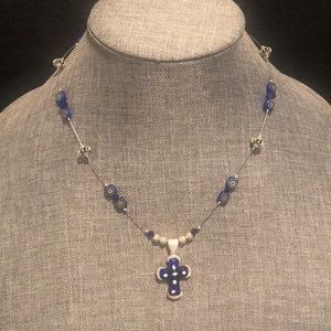 Beautiful 18” necklace with blue glass cross pendant. Sterling silver findings.